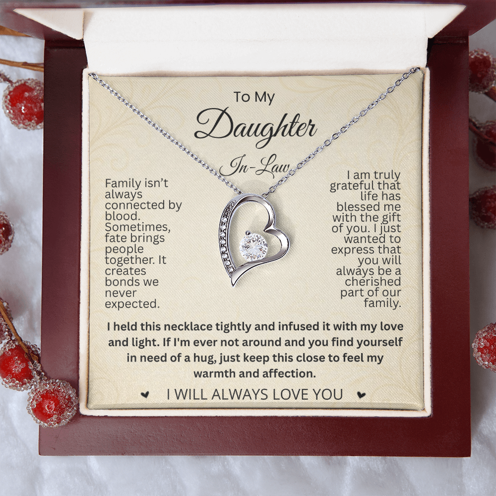 Silver-tone heart necklace and daughter-in-law card in a reddish-brown gift box beside decorative red berries.