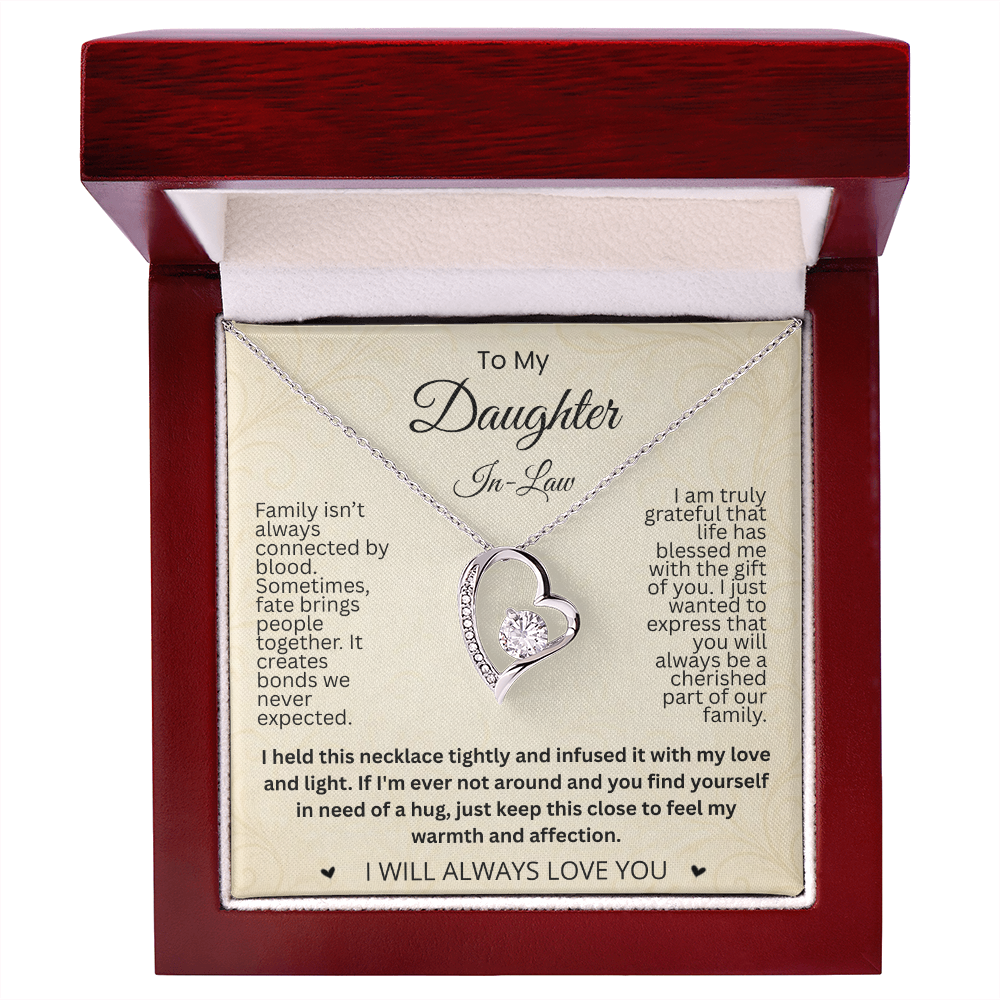 Silver-tone heart necklace and daughter-in-law card in an open reddish-brown gift box on white.