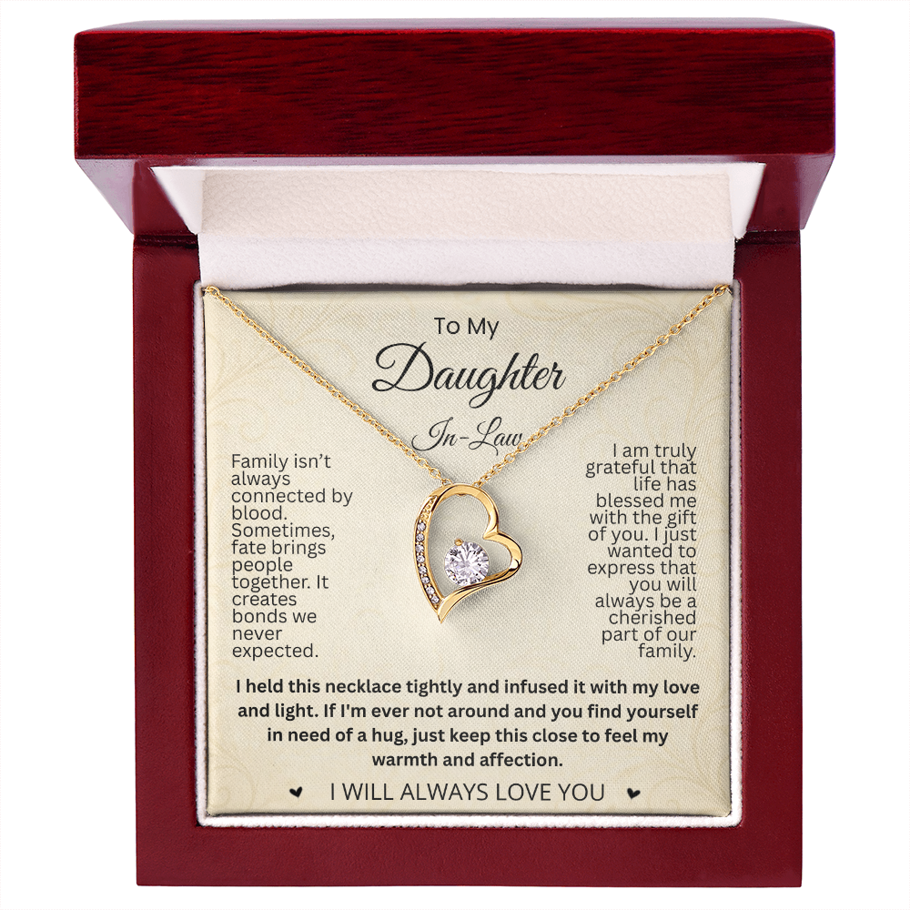 Gold-tone heart necklace and daughter-in-law card in an open reddish-brown gift box on white.