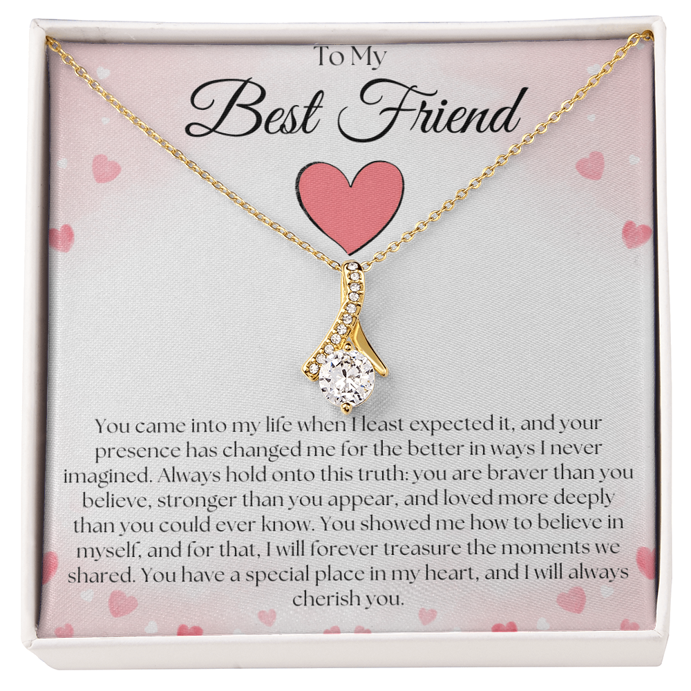 Gold-tone curved pendant necklace with a round clear stone on a pink-heart To My Best Friend card in a white gift box.