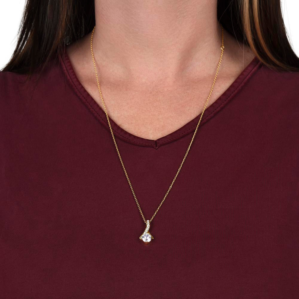 Model wearing the yellow gold-finish Alluring Beauty necklace against a burgundy top.