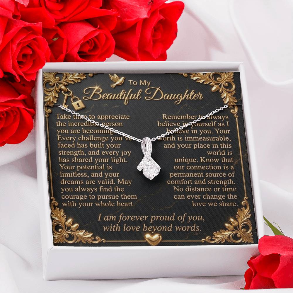 White gold-finish necklace and daughter message card in a standard gift box beside red roses.