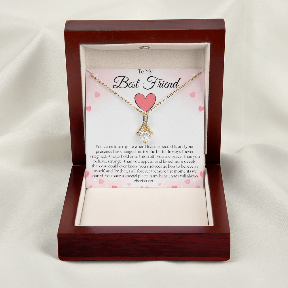 Gold-tone pendant necklace and best-friend card displayed upright in a reddish-brown gift box on white fabric.