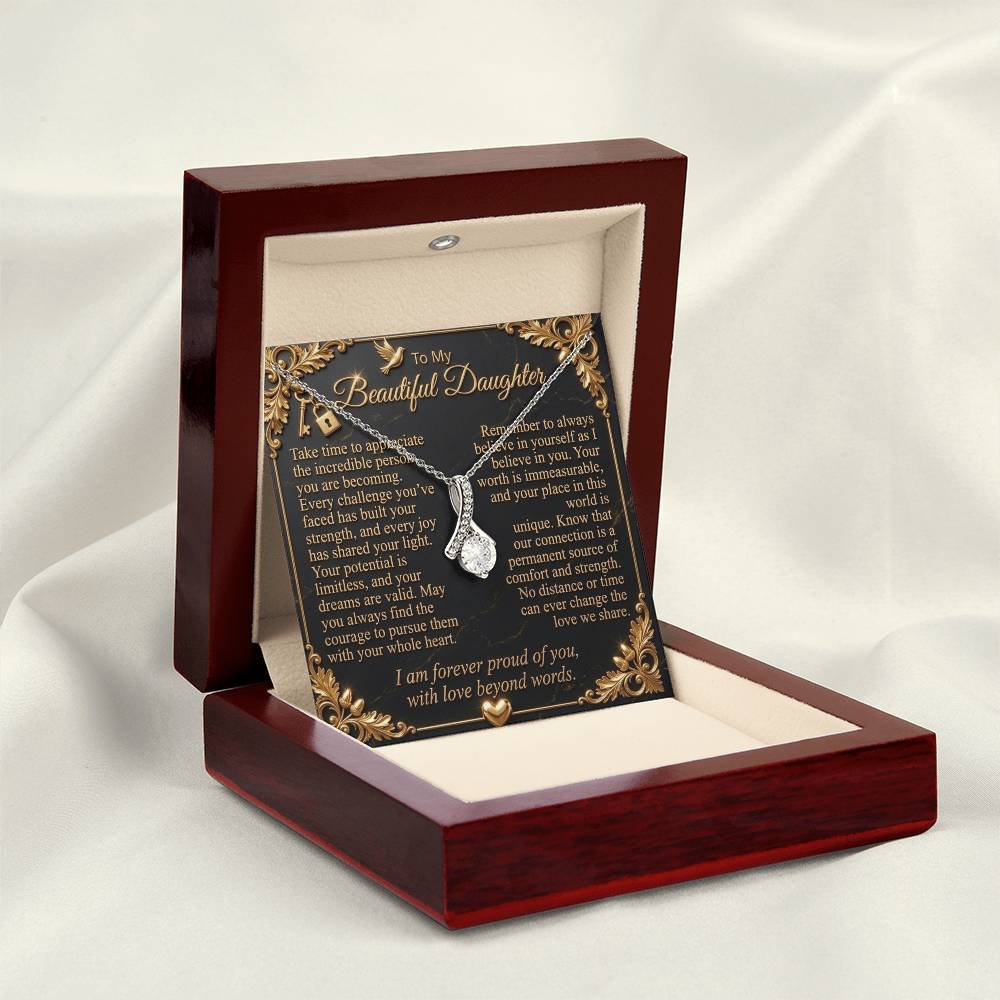 White gold-finish necklace and daughter message card displayed in an open luxury gift box on cream fabric.