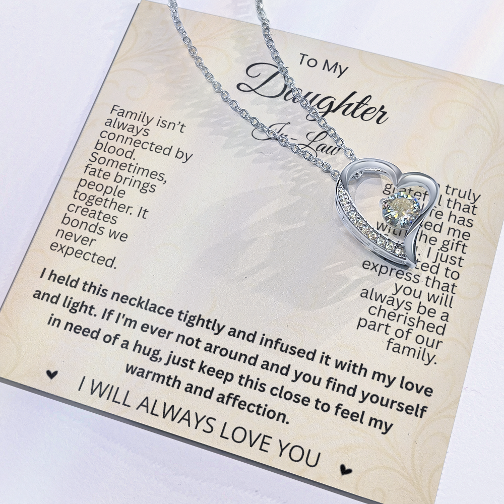 Close-up of a silver-tone heart necklace resting on a cream To My Daughter-in-Law message card.